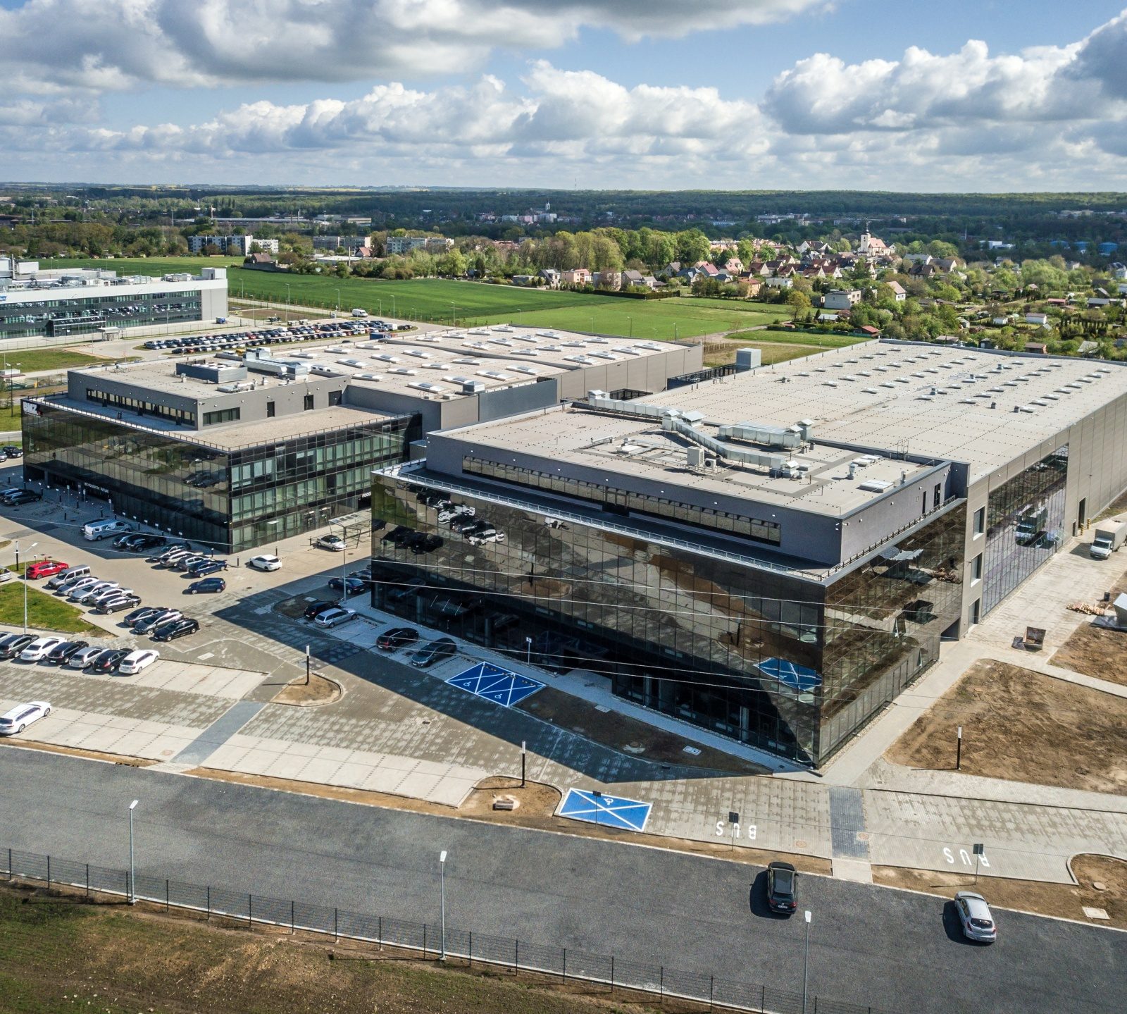 Zdjęcie przedstawia Halę produkcyno - magazynową z częścią scojalnob- biurową i infrastrukturą techniczną BMZ Poland Sp. z o.o. w Gliwicach